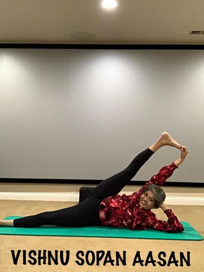 Vishnu Sopan Aasan, a reclining leg stretch, is an advanced posture that demonstrates deep hamstring and hip flexibility. It's a goal to work towards with a consistent practice.