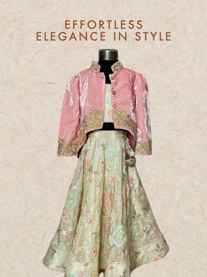 Effortless elegance in a pastel green lehenga with a contrasting pink velvet jacket. The jacket is embroidered with gold thread, adding a touch of luxury to this beautiful ensemble.