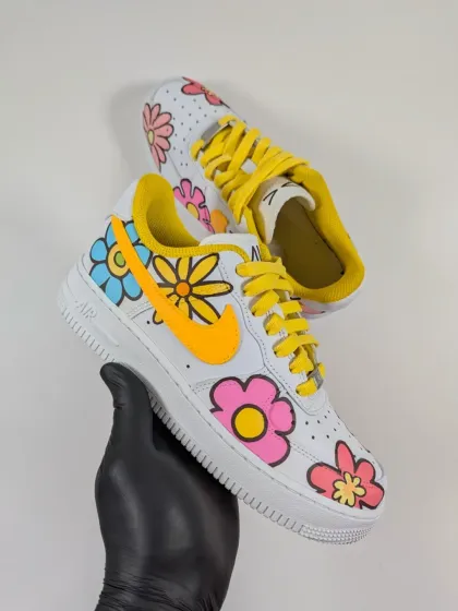 Holding up the completed floral Air Force 1. The design is fun, vibrant, and perfect for anyone who loves flowers.