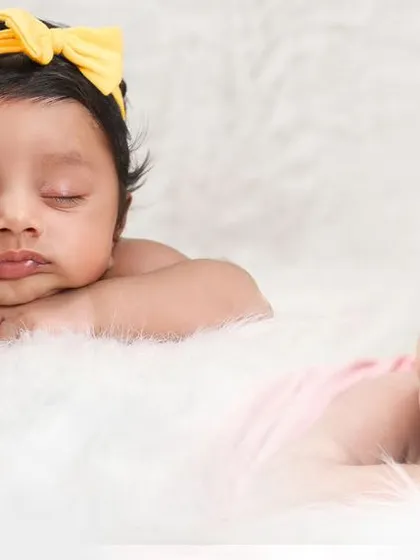 Capturing the different personalities of twins, even from day one. Here, one baby sleeps soundly while the other is awake and looking around.