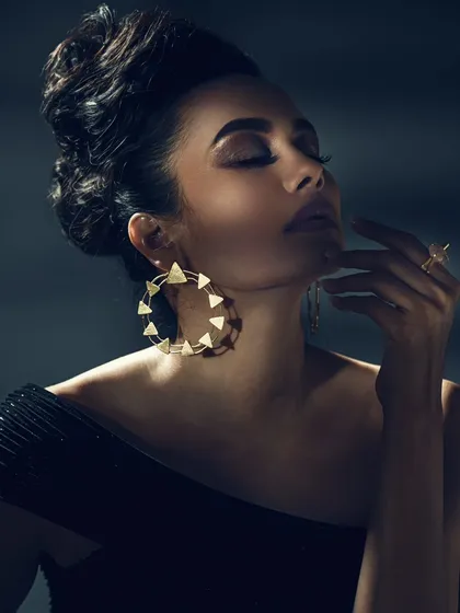 Jewellery photography is all about precision. Here, I used soft, directional lighting to highlight the intricate details of the earrings and ring without creating harsh reflections. The model's pose and expression add a layer of elegance, telling a story beyond just the product.
