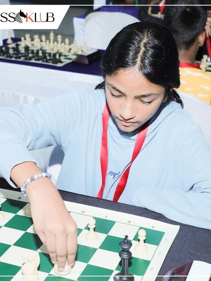 A close up on a player's hand making a move. Every decision counts in a tournament, and our training helps students develop the patience to find the best one.