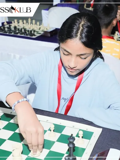 A close up on a player's hand making a move. Every decision counts in a tournament, and our training helps students develop the patience to find the best one.