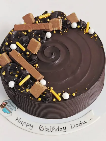 A rich chocolate cake decorated with KitKat bars and golden sprinkles. A simple yet decadent choice for any chocolate lover's birthday.