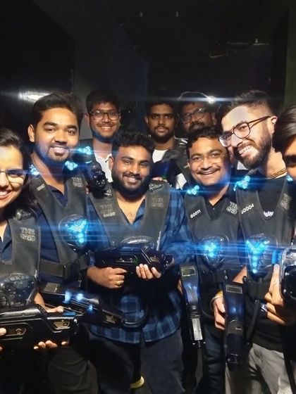 A group of friends smiling and posing after a fun laser tag session.