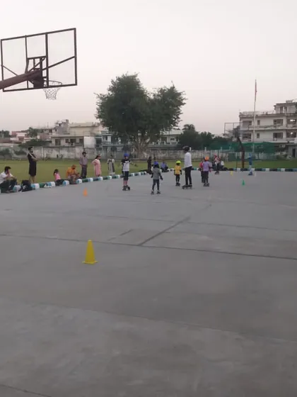 Another angle of the children's skating class, showing the spaciousness of the court which allows for safe practice.
