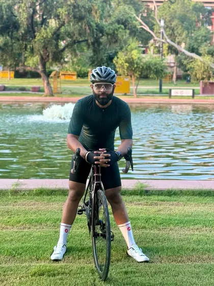 A creative pose with the bike in a grassy area.