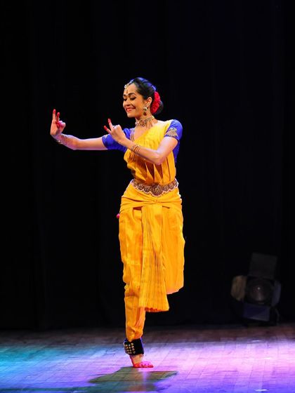 A classic pose that requires both stability and fluidity, embodying the core principles of the dance form. This was captured during a live festival performance.