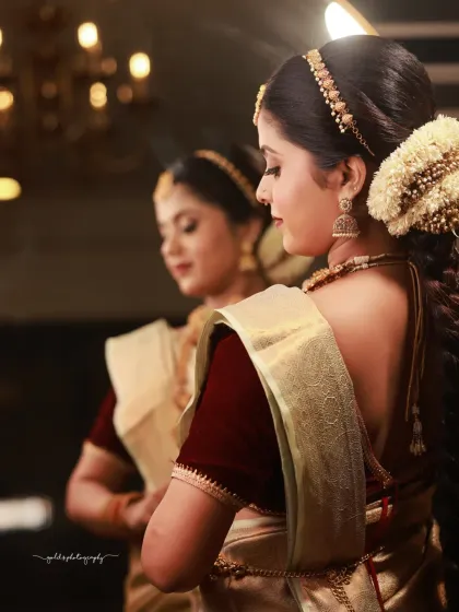 A beautiful reflection shot that captures two angles at once. The focus on the bride's profile in the mirror adds a layer of depth and artistry to the portrait.
