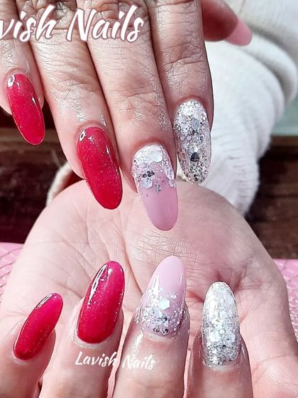 A fun and vibrant set with bright pink nails and accent nails featuring a silver and pink glitter fade.