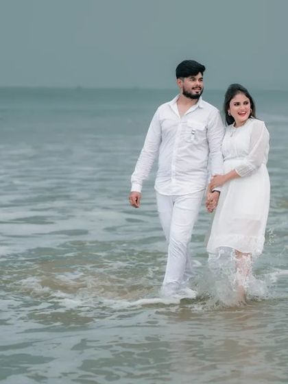 A classic, romantic walk on the beach. This timeless pre-wedding photo captures the couple's connection in a beautiful, natural setting.