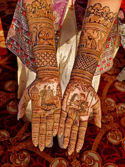 A romantic story told through henna. This design includes a couple's portrait on a swing, a varmala ceremony, and traditional elements like elephants and peacocks.
