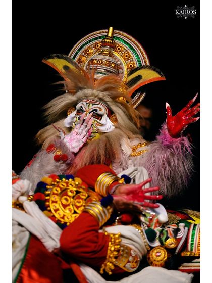A full-body shot capturing the dramatic storytelling and expressive body language of the Kathakali art form.