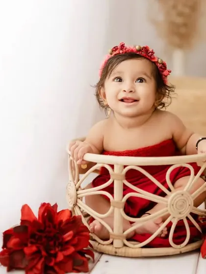 A beautiful, happy smile from a 6-month-old girl in our red-themed sitter session. Her joy is absolutely contagious.
