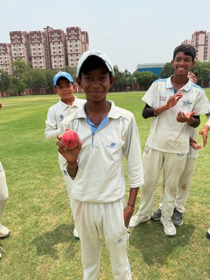 Taresh Saini all smiles after taking a 5-wicket haul. It's a huge achievement for any bowler, and his teammates are there to cheer him on.