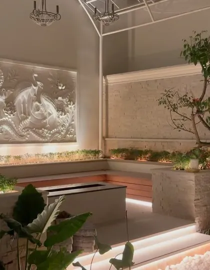 This is an example of a high-end interior courtyard we executed. The project features a stunning bas-relief wall, multi-level planters with integrated seating, and sophisticated lighting to create a serene and luxurious atmosphere, proving that any space can become a work of art.