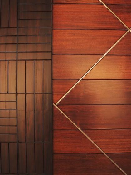 A detail of two different wood paneling styles side-by-side, showcasing geometric and linear patterns.