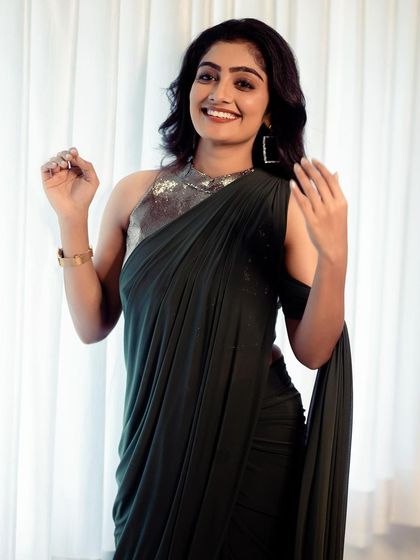 A beautiful shot of our dark green ready to wear drape saree. The halter neck blouse has a subtle shimmer that perfectly complements the elegant drape of the saree.