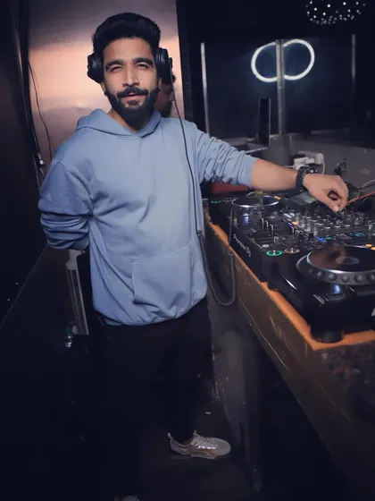 A more casual look from a recent gig. Whether it's a hoodie or a suit, the focus on the music and the crowd is always the same.