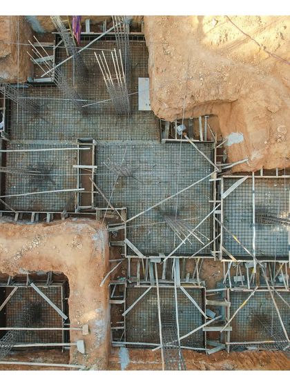 An aerial drone shot of the foundation work for project 'C-36', showing the very first stage of construction.