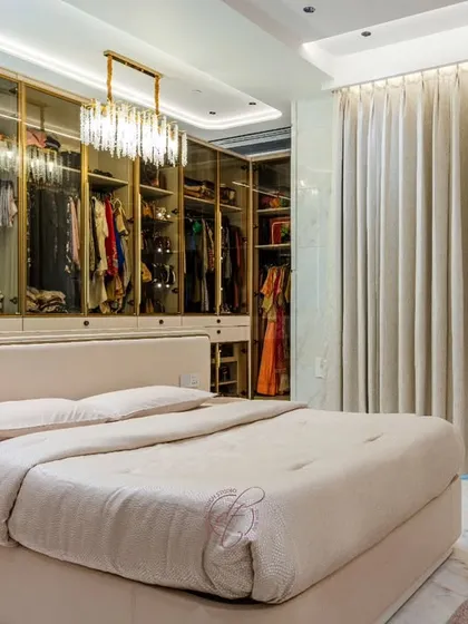 A closer look at the bed and its relationship with the walk-in closet. The design demonstrates how storage can be both highly functional and a beautiful design element.