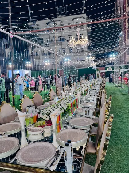 This is the standard I set for a grand celebration. A beautifully arranged sit-down dinner with mirrored tables reflecting the fairy lights, elegant floral centerpieces, and impeccable place settings, all ready for your guests to arrive.