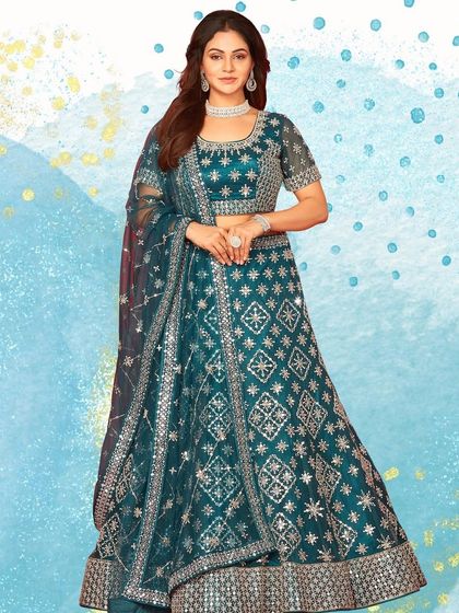 Another look at the beautiful teal lehenga with geometric patterns. The color is vibrant and the mirror work adds the perfect amount of sparkle for an evening function.