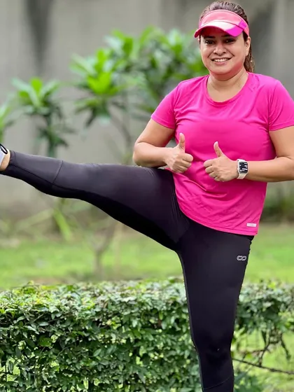 A member showing off her flexibility with a post-run stretch. We encourage a holistic approach to fitness that goes beyond just running.