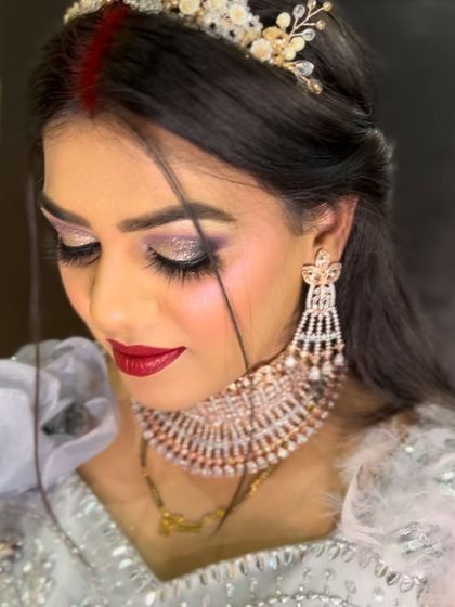 A stunning reception look with glittery eyes and a bold red lip.