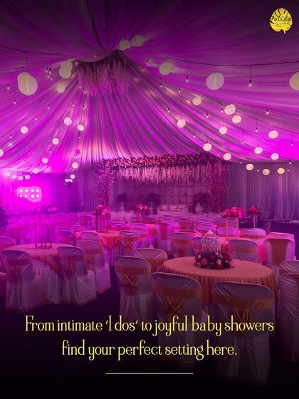 An indoor hall transformed with dramatic pink lighting and draped ceilings. We can create any mood, from intimate 'I dos' to grand, joyful receptions.
