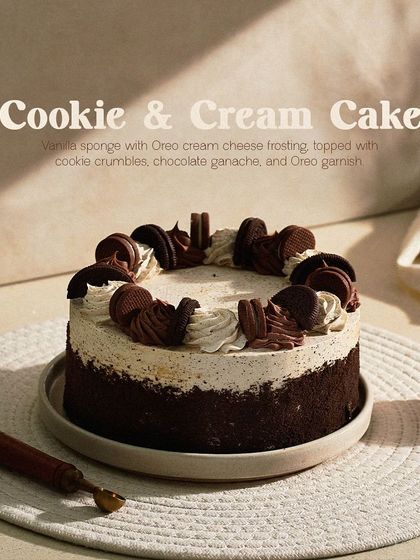 My Cookie & Cream Cake, a classic favorite. It's made with vanilla sponge, Oreo cream cheese frosting, and generously garnished with whole and crumbled Oreo cookies.