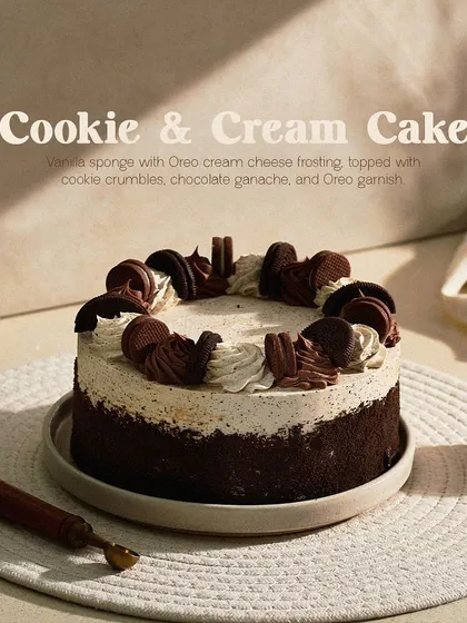 My Cookie & Cream Cake, a classic favorite. It's made with vanilla sponge, Oreo cream cheese frosting, and generously garnished with whole and crumbled Oreo cookies.