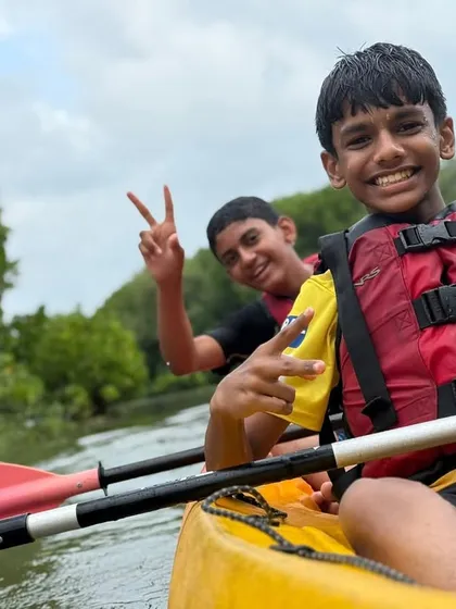 The joy of mastering a new skill is clear on this young camper's face during a kayaking session at our Malpe camp. We provide all the gear and guidance needed for a safe and fun introduction to paddling.
