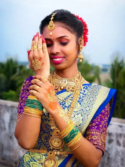 Capturing the grace of tradition. This outdoor portrait from a puberty ceremony highlights the intricate details of the gold jewelry and silk saree, using natural light to create a soft and radiant look.