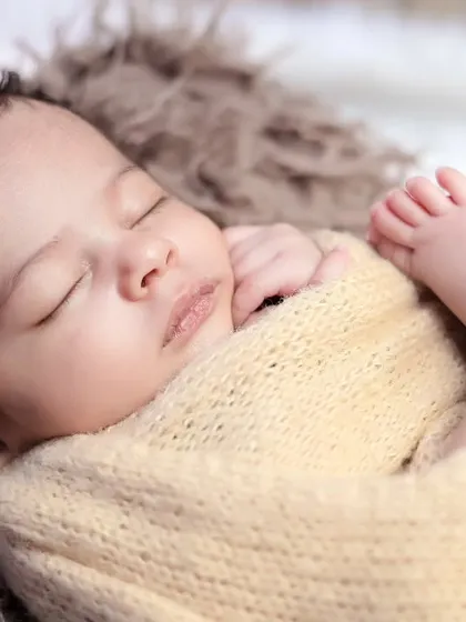 A detailed close-up of a sleeping newborn's face and feet. These macro shots capture the delicate features you'll want to remember forever.