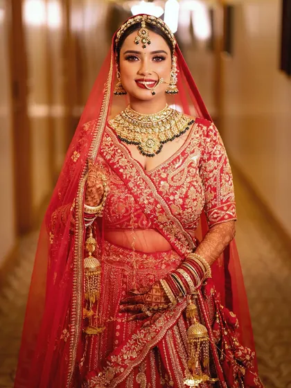 This bride was an absolute vision in her red lehenga. I created a classic bridal look with a bold red lip and softly defined eyes that perfectly matched the royal and unforgettable vibe of her wedding day.
