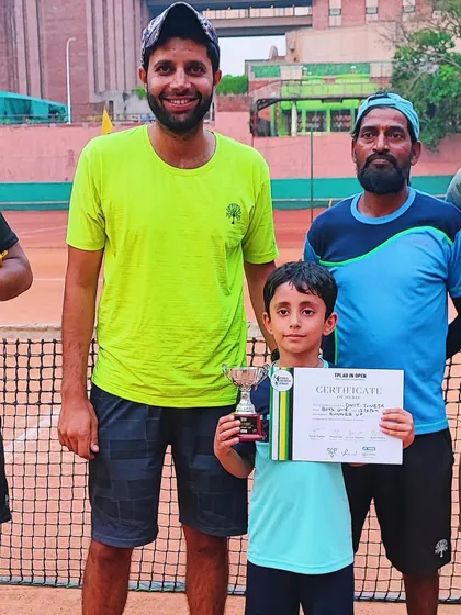 The competition is getting fierce, and we love it. A young winner with his trophy and coaches.