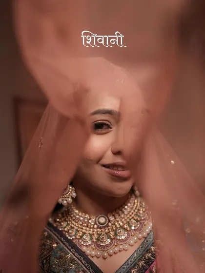 A playful and intimate peek through the veil. This close-up of bride Shivani captures her personality and the beautiful details of her bridal look.