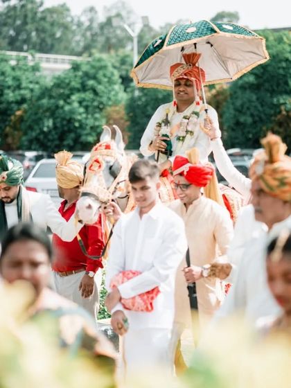The groom's grand entrance, or baraat, on a decorated horse. We capture the energy and celebration of this fun tradition.