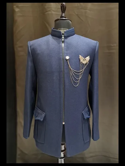 The final sketch of this indigo blue bandhgala became this stunning reality. It features a textured fabric, front zipper, and a custom metal brooch with a chain for a touch of military-inspired flair.