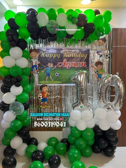 A football-themed balloon arch in green, black, and white for a 10th birthday. A great choice for young sports fans.