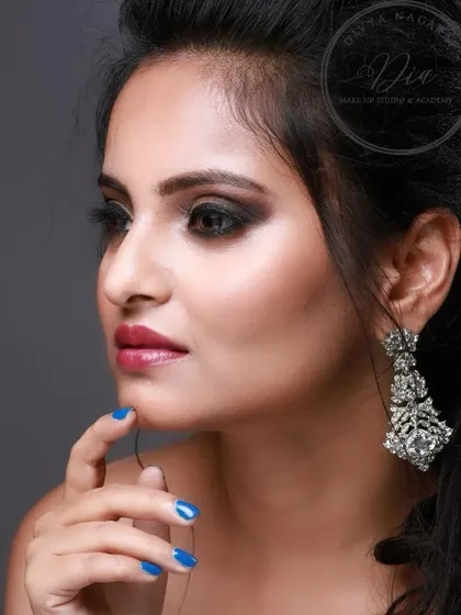 A side profile of this stunning cocktail makeup. The focus is on the beautifully blended smoky eye and the glowing highlight on her cheekbones.