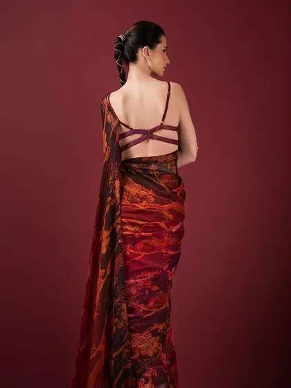 The back of this printed saree from Q by Sonia reveals a modern and strappy blouse design, adding a contemporary edge to a traditional look.