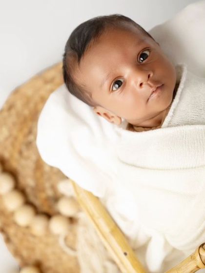 A close-up shot capturing the newborn's beautiful, wide eyes. These moments of connection are incredibly special to capture.