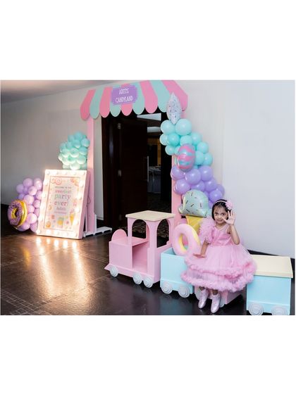 A duplicate image of the birthday girl enjoying her Candyland party entrance.