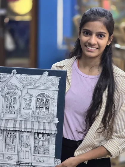 A proud student showcasing her intricate architectural drawing. Created with a micron pen on canvas, this piece highlights the precision and patience we teach in our technical drawing and illustration programs.