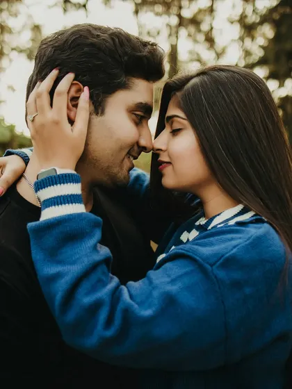 An intimate close-up of the couple, their faces close as they share a loving gaze. This candid moment in a natural, outdoor setting captures the pure and simple essence of their connection.