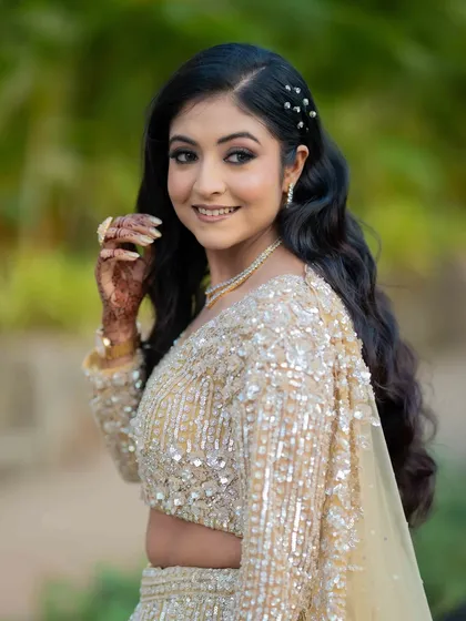 Glowing in gold. This look is all about enhancing her natural beauty with soft eyes, radiant skin, and a touch of sparkle.