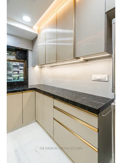 This shot highlights the sleek, handle-less drawers with gold-finished trim, adding a touch of understated luxury to the minimalist design.