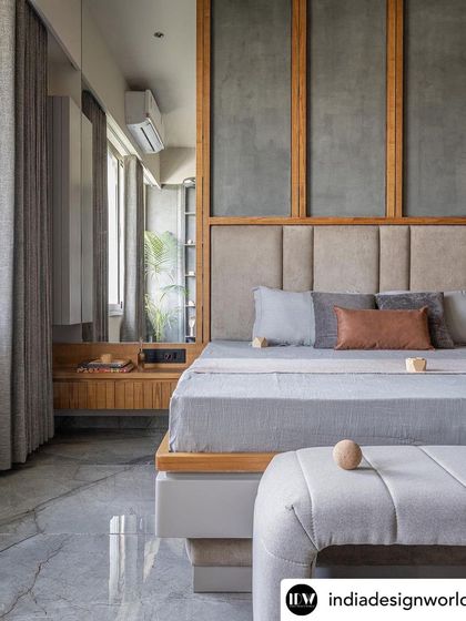 In this bedroom, I used a combination of wood framing, concrete-finish panels, and an upholstered headboard to create a layered and tactile feature wall. The floating nightstand and mirrored wardrobe enhance the sense of space, making the room feel larger and brighter.